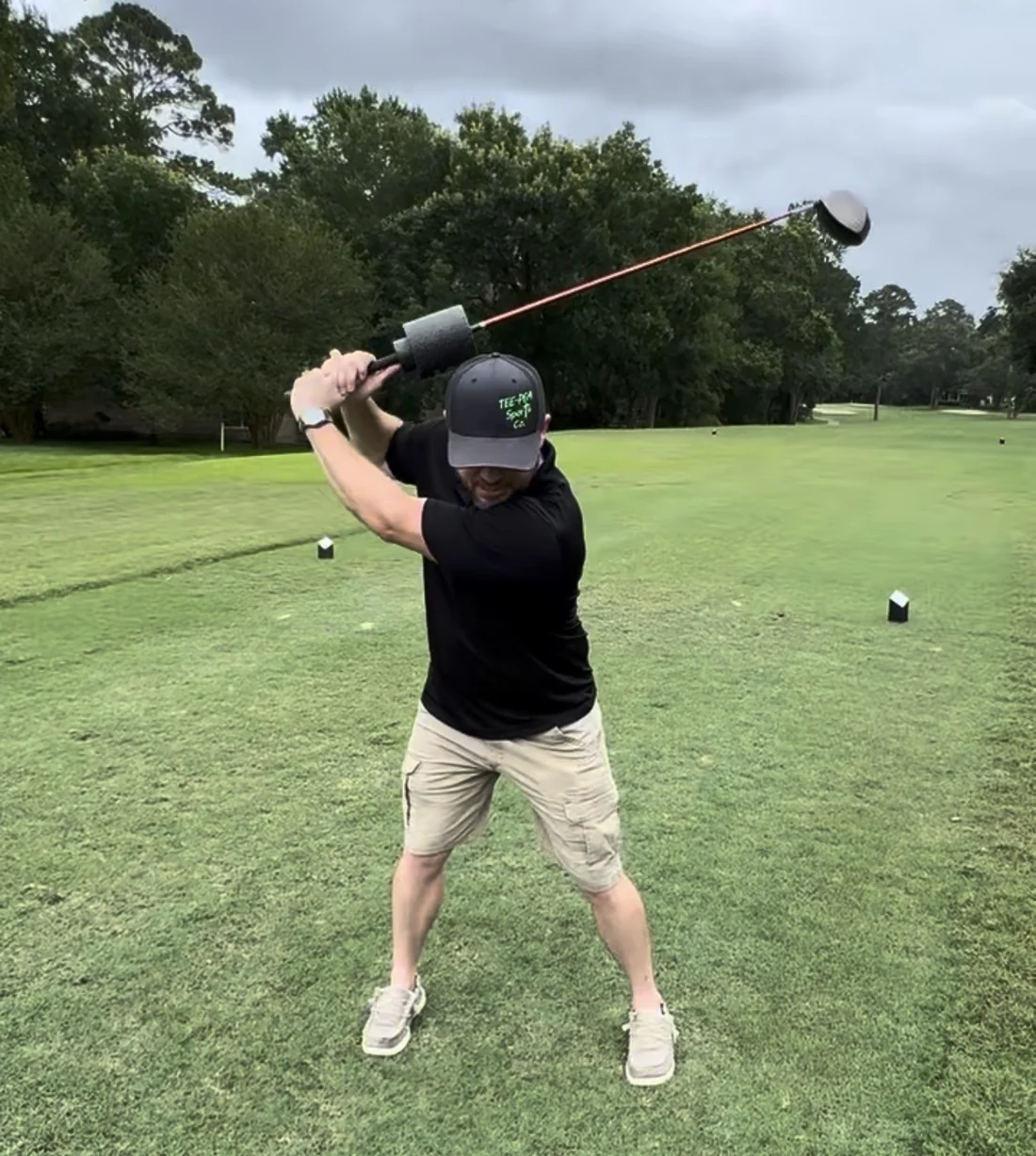 Golfer training with Tee-Pea Roll on a golf club